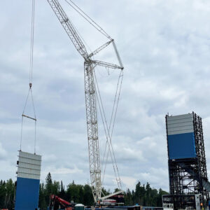 Alamos Gold's Island Phase 3+ Expansion Project Image was taken of on-site construction that shows a crane being used to install structural steel for a modular building.